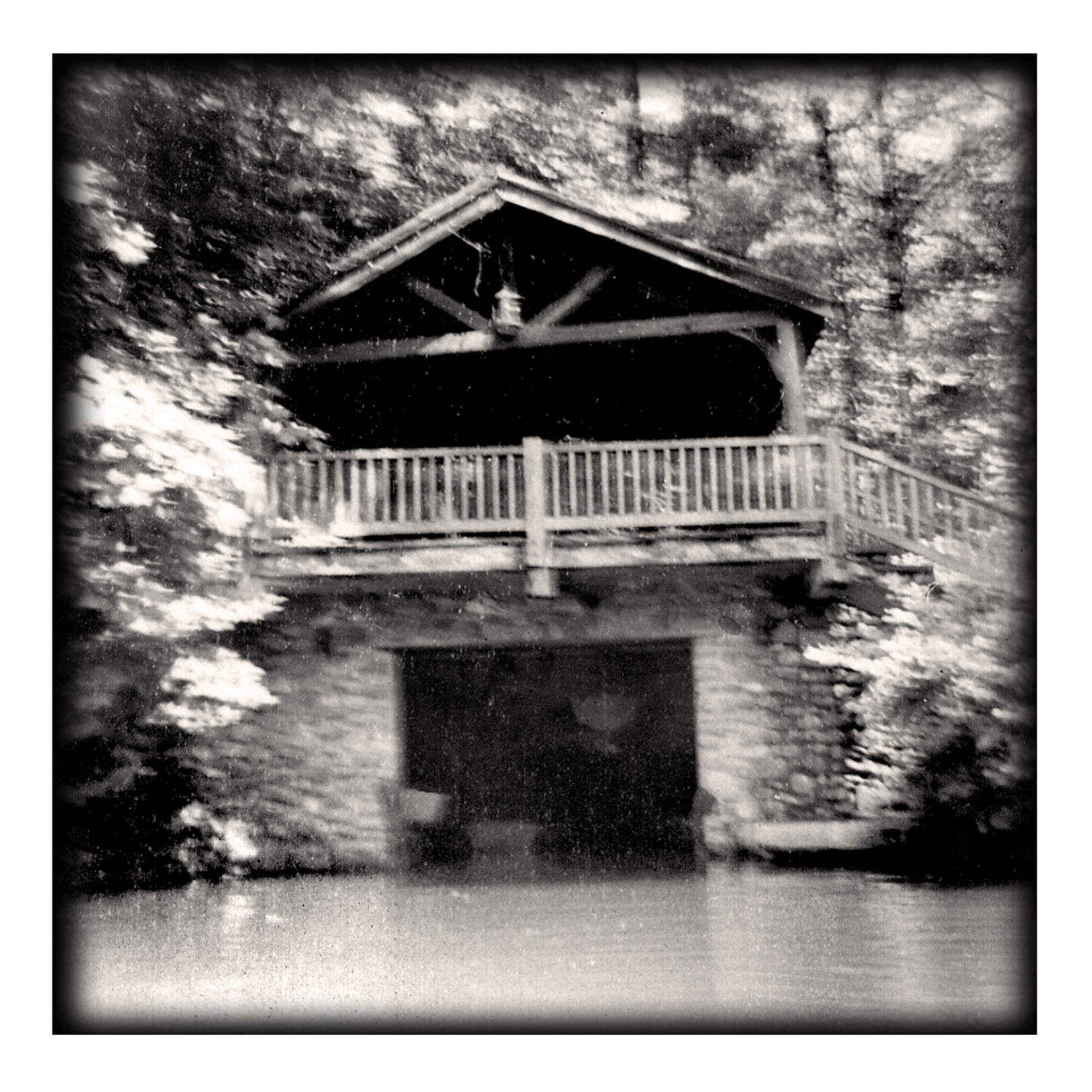 The Devotion boat house in 1953 — a timber-framed shelter with a railed deck above a stone boat slip open to the lake