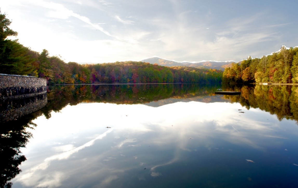 Autumn view across the lake at Devotion, with the dam wall at left and the foothill ridgelines beyond